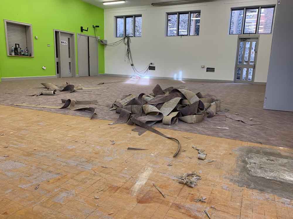 Removing old flooring in church in Guildford