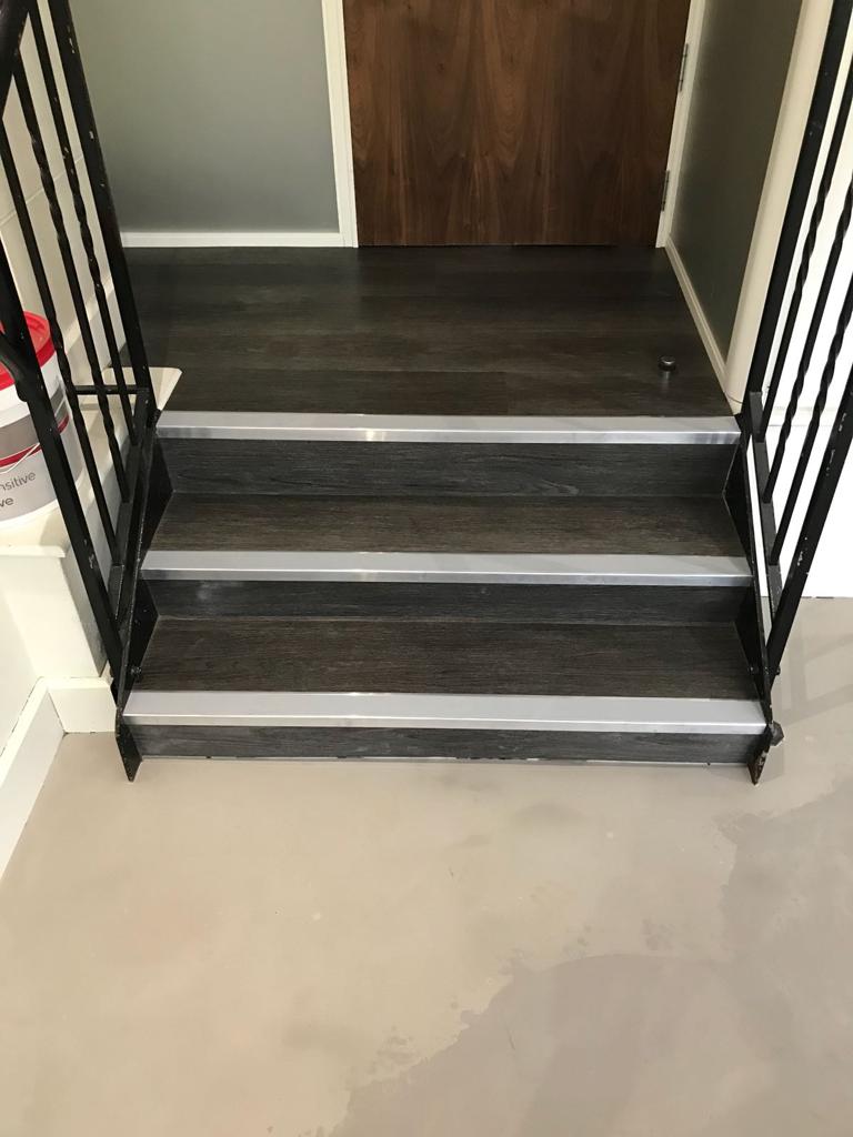 Installation of Polyflor commercial luxury vinyl tile on stairs with stair nosings